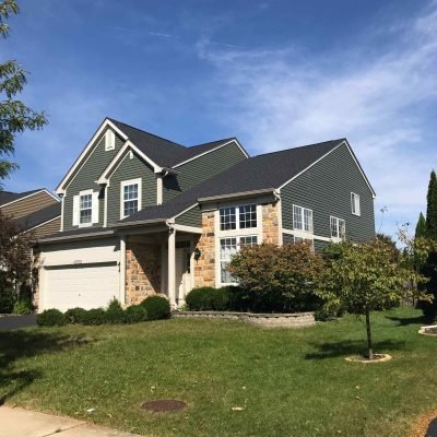 Two-story home in Arlington Heights with new dark green roof and siding by Green Renovations LLC