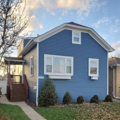 Blue residential house with newly updated roof installed by Green Renovations LLC
