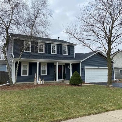Two-story suburban home with professionally installed asphalt shingle roof