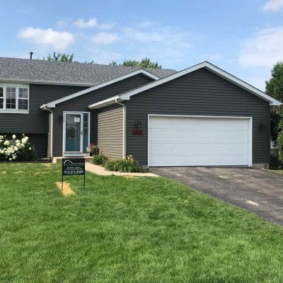 Modern single-story home featuring freshly installed gray asphalt shingle roof